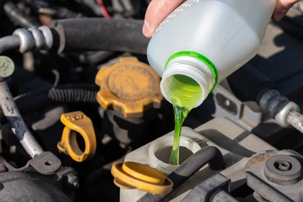 coolant being poured into a reservoir  